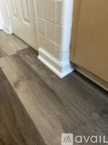 A room with a wooden floor and white trim.