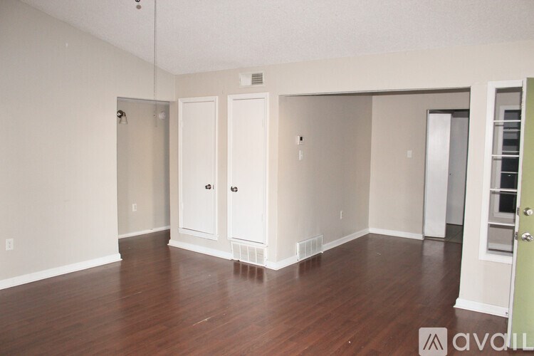 A room with wood floors and white walls.