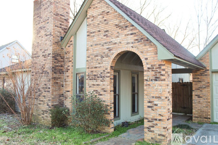 A brick house with a door and windows.