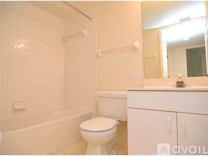 A white bathroom with a toilet, sink, and bathtub.
