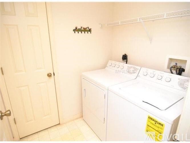 A small laundry room with a washer and dryer.