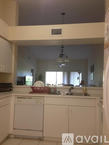 A kitchen with white cabinets and a dishwasher.
