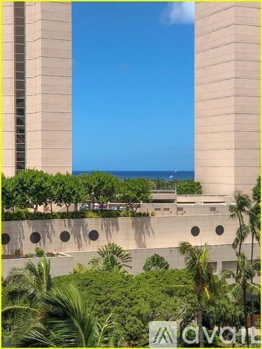 A tall building with a clear blue sky in the background.