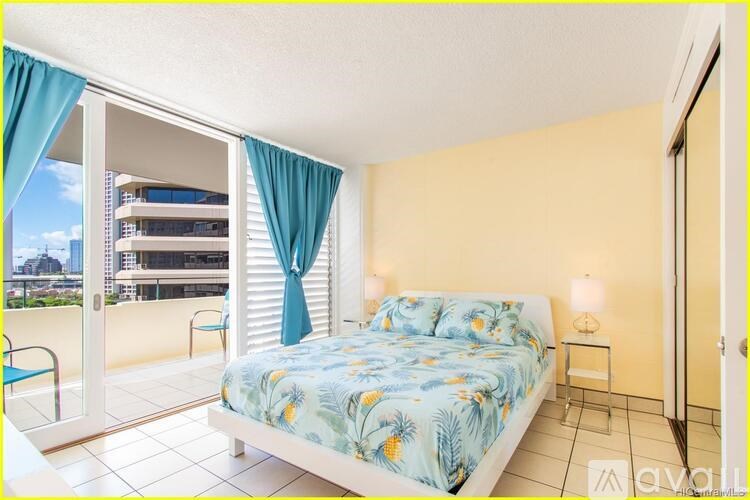 A bedroom with a large bed and a view of the city.