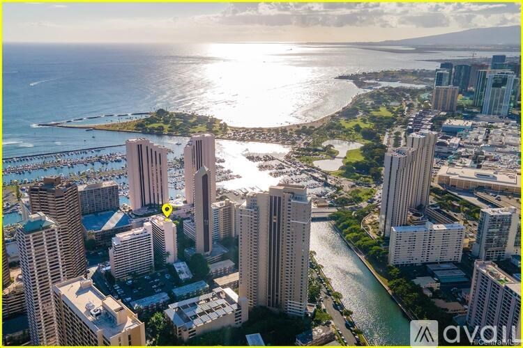 A cityscape with a river running through it and a yellow marker on one of the buildings.