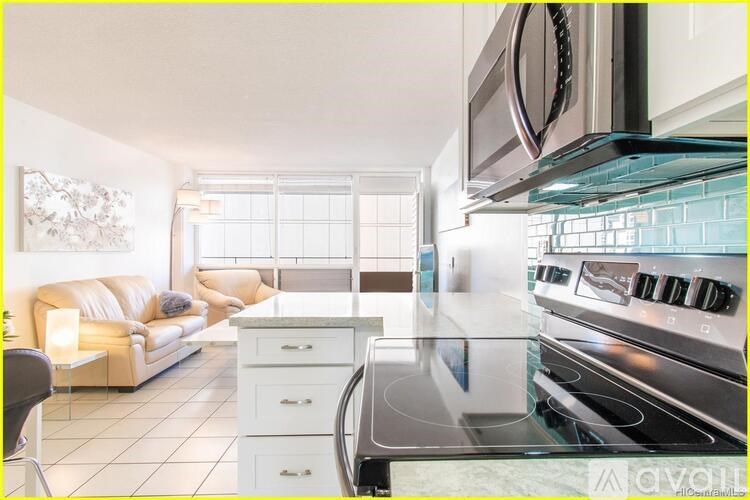 A modern kitchen with a stove top oven and a counter top.