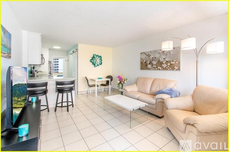 A living room with a white couch and a coffee table.