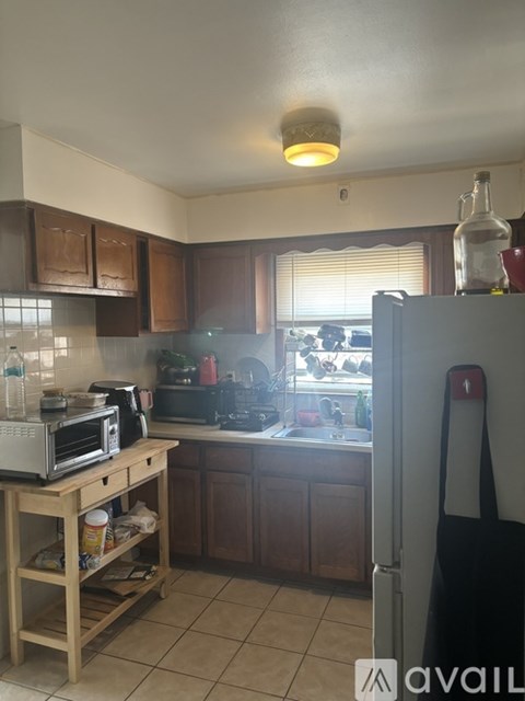 A kitchen with a microwave, oven, and refrigerator.