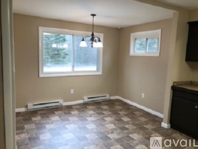 A room with a checkered floor and a window.