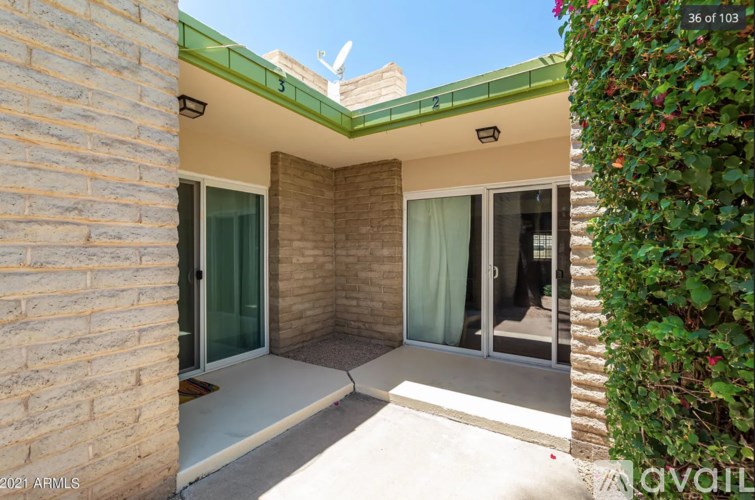 A balcony with a glass door and a glass window.