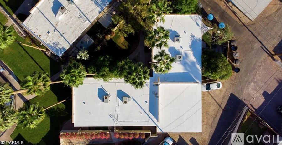 A bird's eye view of a residential area with houses and cars.