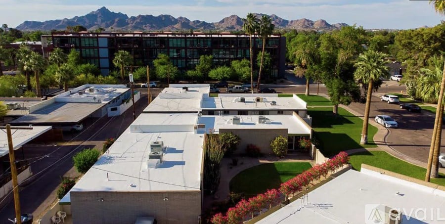 A large building complex with a parking lot in front.