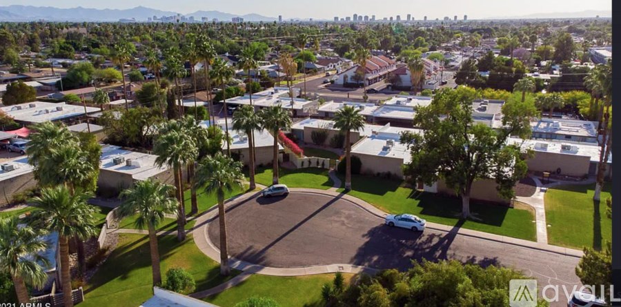 A bird's eye view of a residential area with a large house in the center.