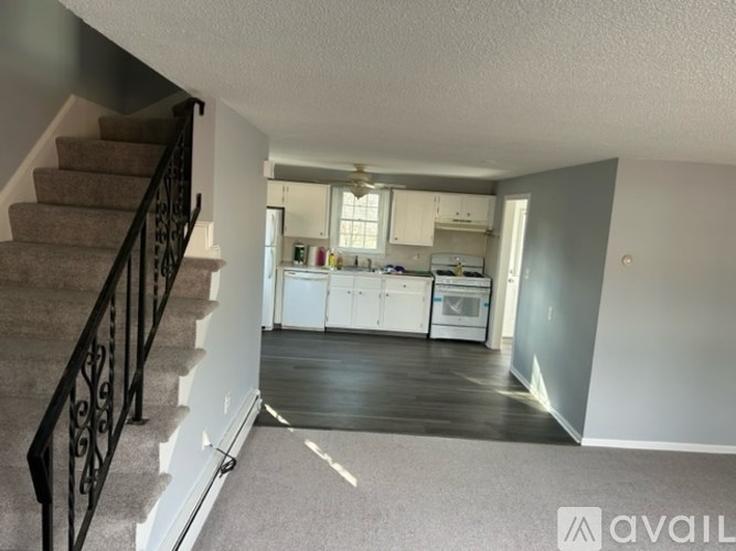 A living room with a staircase leading to the upper floor.