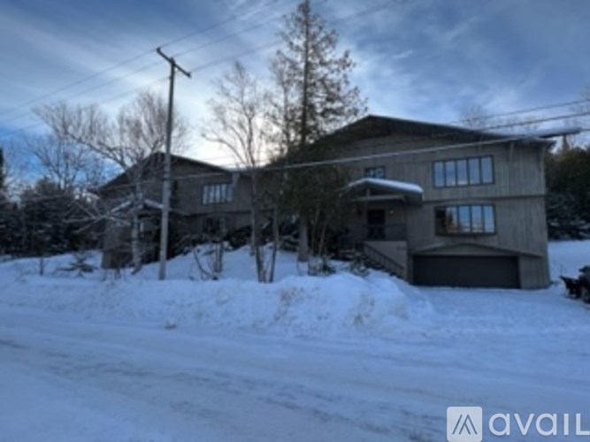 A house with a snowy front yard.
