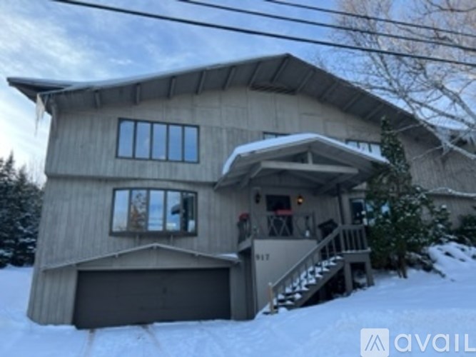 A house with a garage and a snow-covered ground.