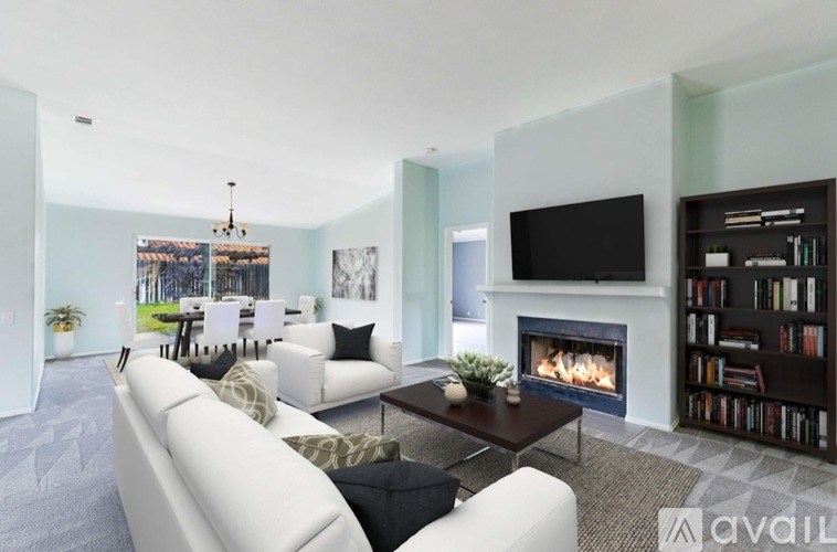 A living room with a fireplace and a television.