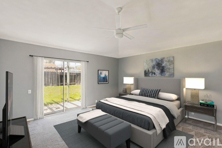 A bedroom with a large bed and a television.