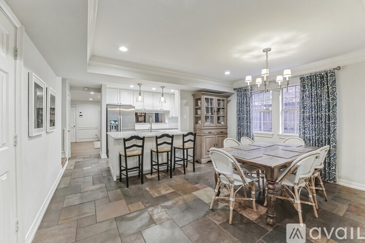 A dining room with a table set for four.