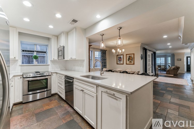 A modern kitchen with a large island and stainless steel appliances.
