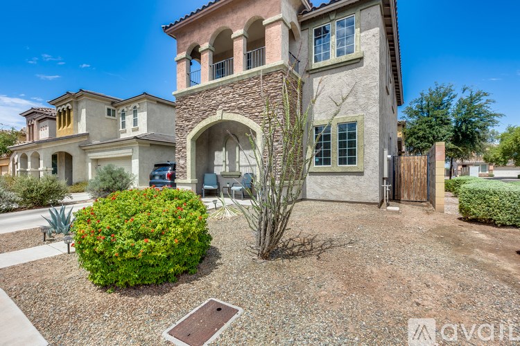 A house with a stone archway entrance and a small garden in front.