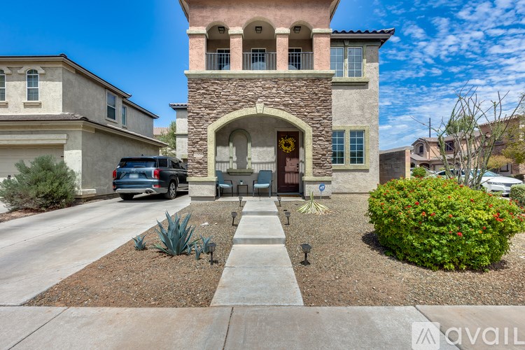 A house with a stone archway entrance and a landscaped front yard.