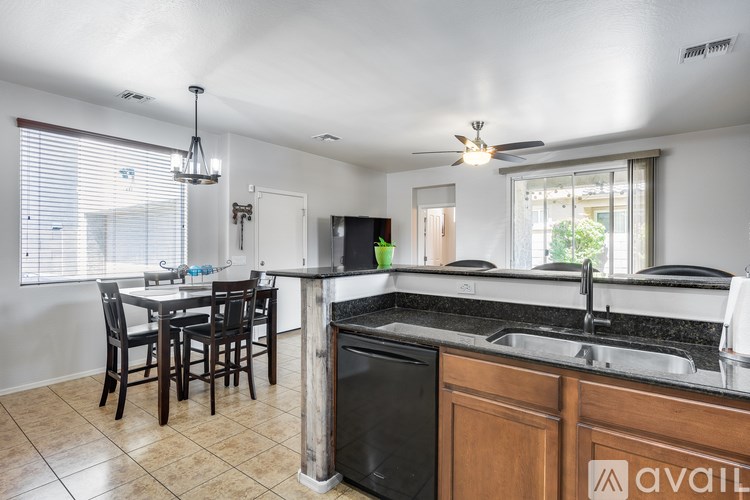 A kitchen with a table and chairs is available for rent.