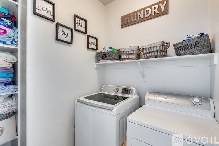 Laundry room with washer and dryer and storage baskets.