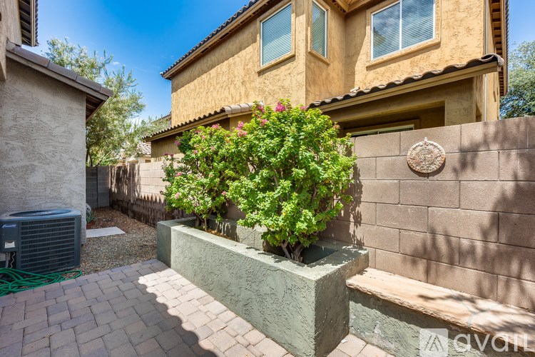A house with a wall and a planter box.