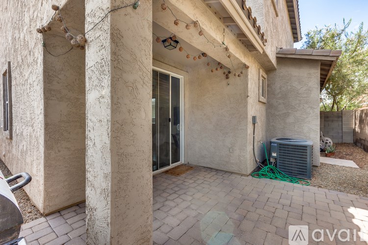 A patio area with a wall and a door.