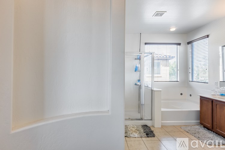 A bathroom with a tub, shower, and sink.