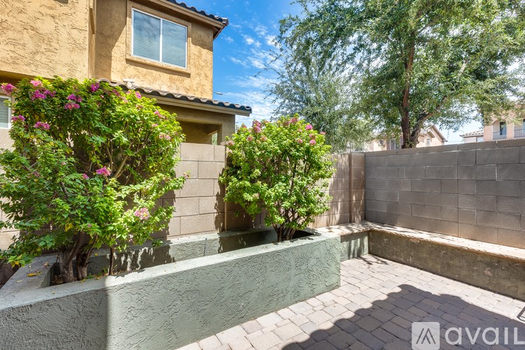 A house with a green wall and a tree in front.