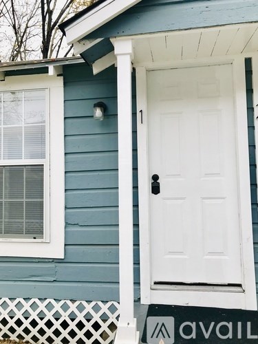 A blue house with a white door and window.