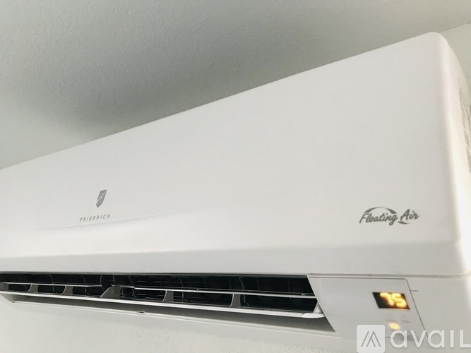 A white air conditioner unit with the brand name Friedrich and the model name Floating Air.