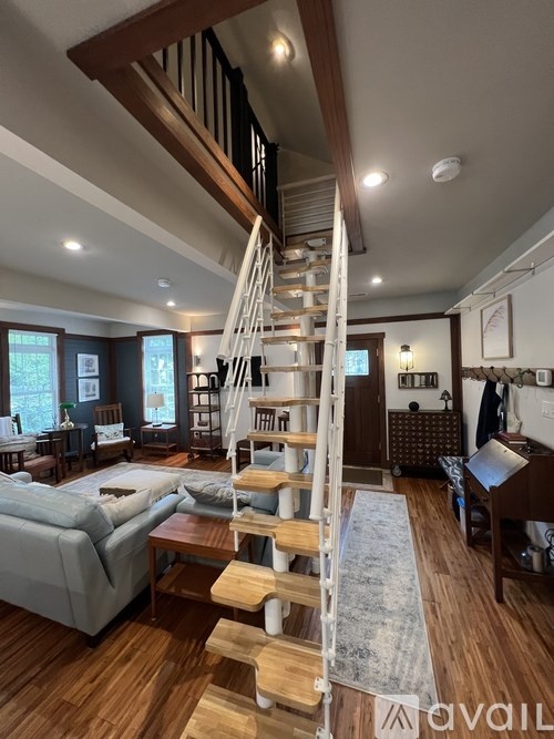 A living room with a staircase leading to the upper floor.