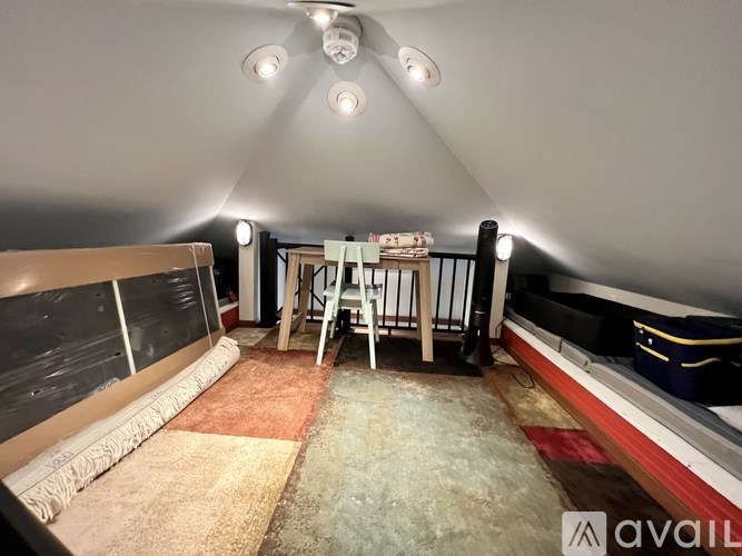 A room with a carpeted floor and a ladder.