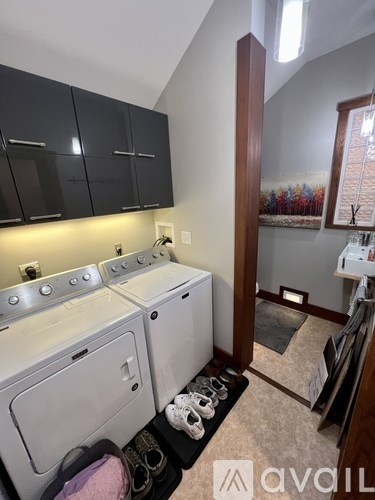 A small laundry room with a washer and dryer.