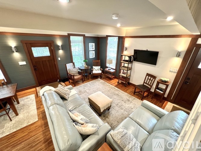 A living room with a grey sofa and a wooden table.