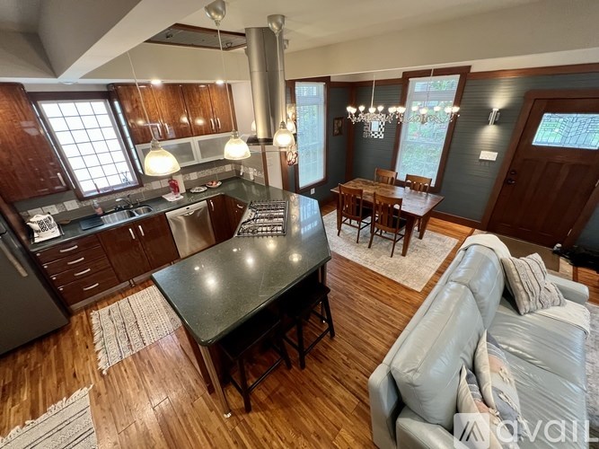 A kitchen with a table and chairs in the middle of the room.