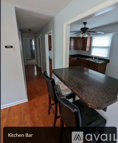 A kitchen bar with a table and chairs.