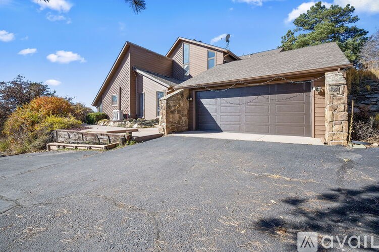 A house with a garage and driveway in front of it.