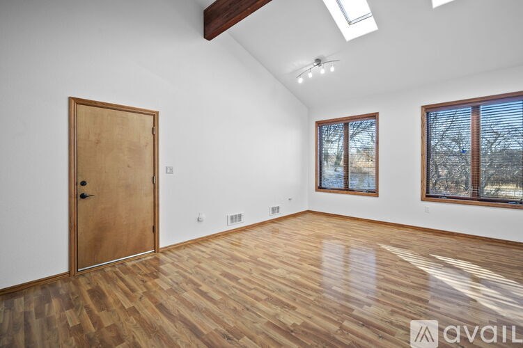 A room with wooden floors and a large door.