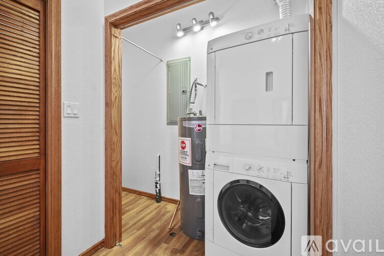 A white washing machine and dryer in a small laundry room.