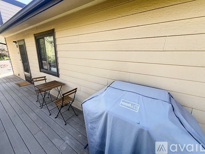 A covered patio table is on a deck.