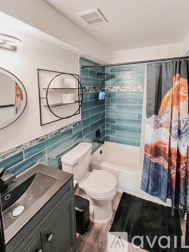 A bathroom with a toilet, sink, and shower.