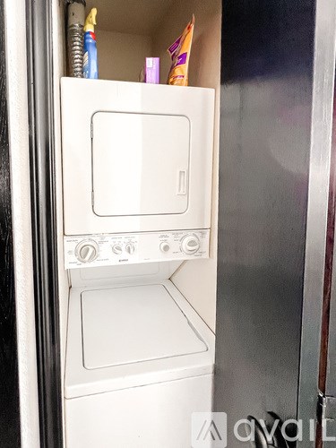 A white oven with a door open is in a kitchen.