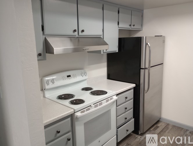 A modern kitchen with a stove, oven, and refrigerator.