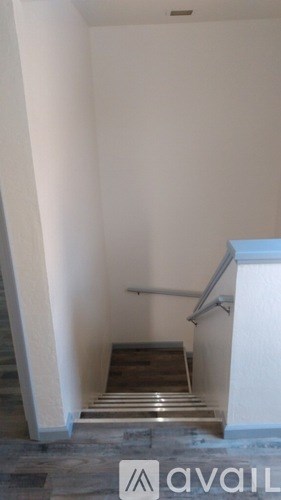 A staircase with a metal railing and stone steps.