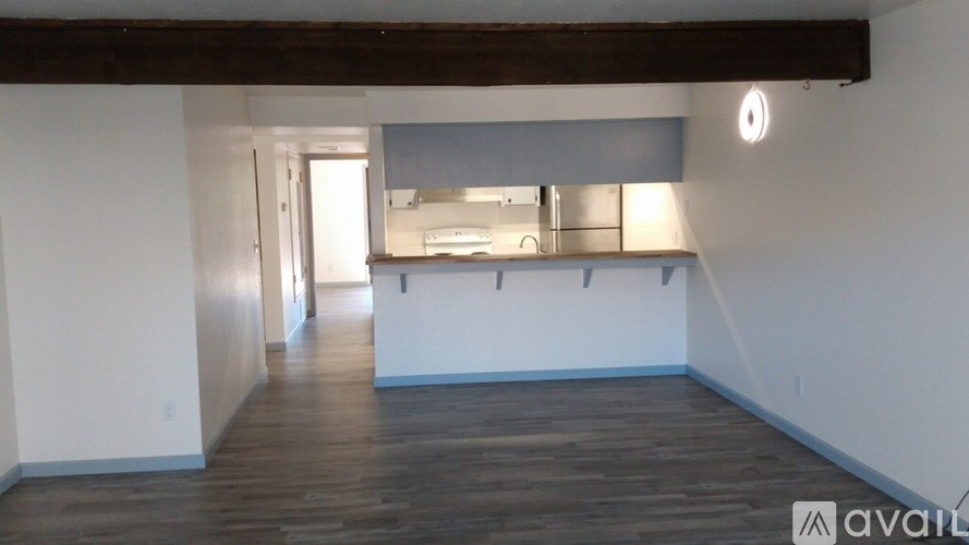 A room with wooden floors and white walls.