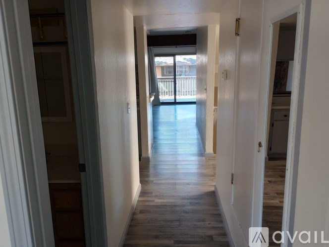 A long hallway with a door at the end.